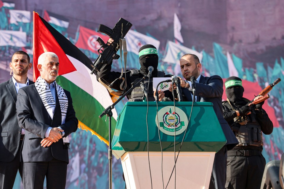 Sinwar watches on as one of his Hamas terrorists raises a gun in the air