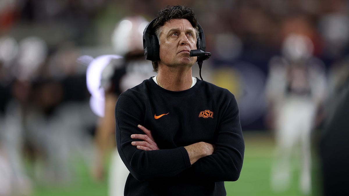 Mike Gundy looks on