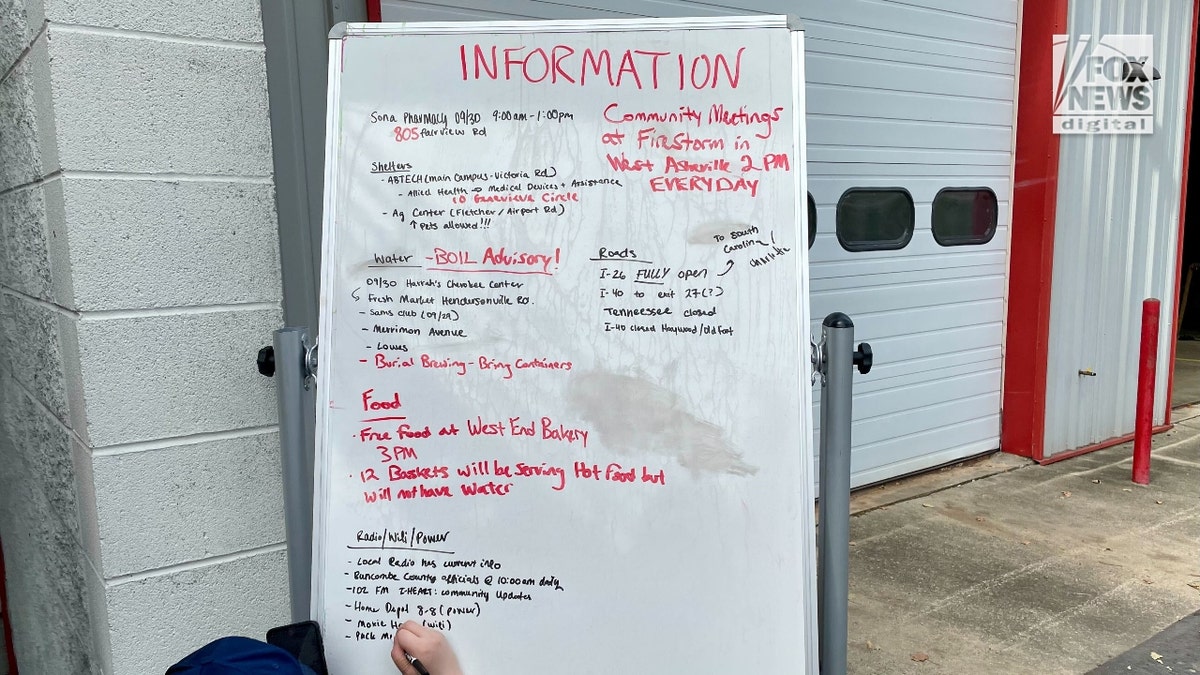 Volunteers stationed at the Fairview Fire Department write down relief information on a white board.