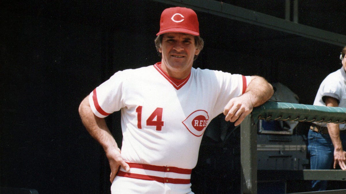 Pete Rose poses on dugout