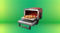 Ninja woodfire pizza oven against a green background.