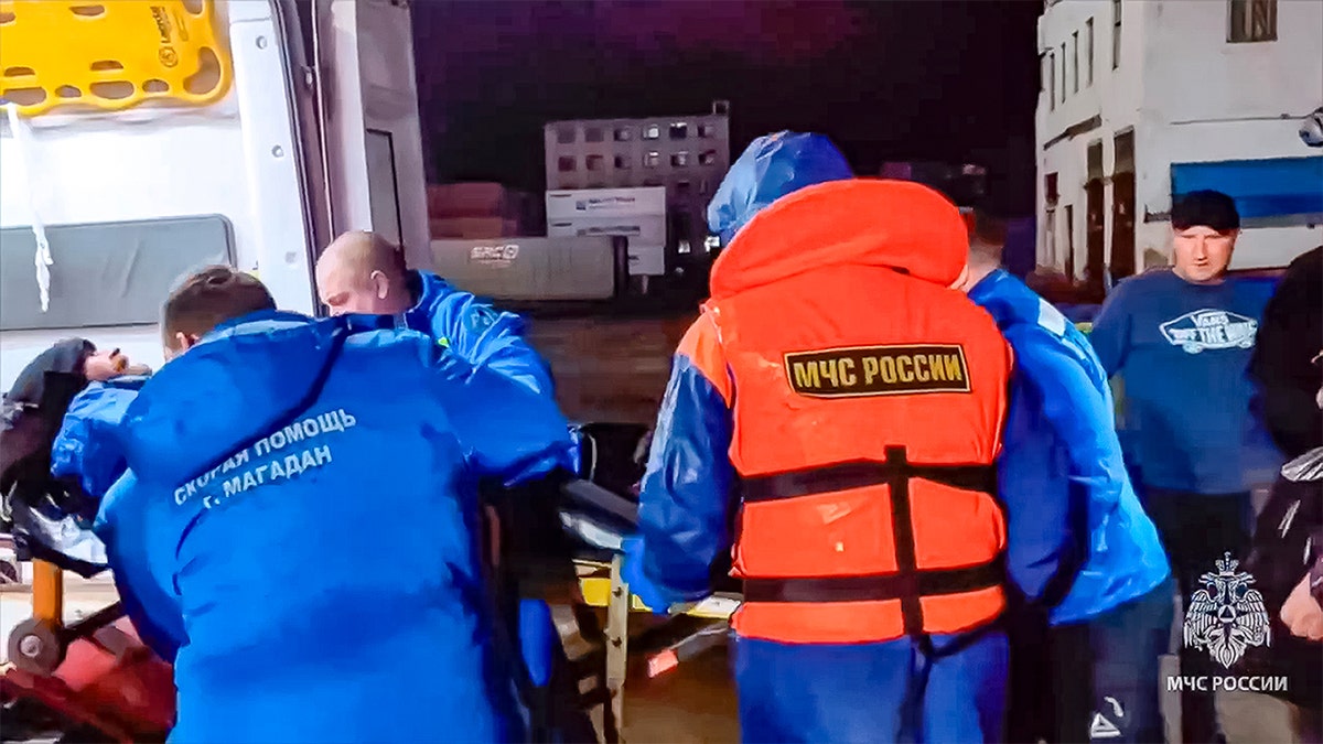 Russian emergency workers attend to Mikhail Pichugin