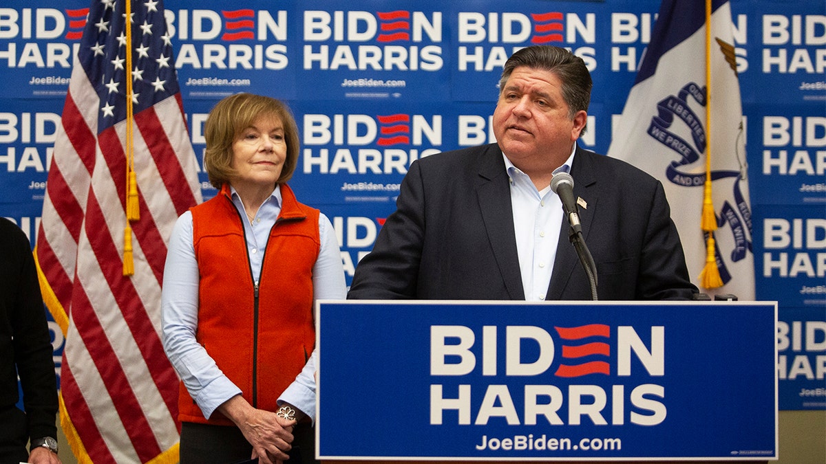 Sen. Tina Smith, D-Minn., and Illinois Gov. J.B. Pritzker at a news conference hosted by Biden-Harris 2024 National Advisory Board members in Des Moines, Iowa.