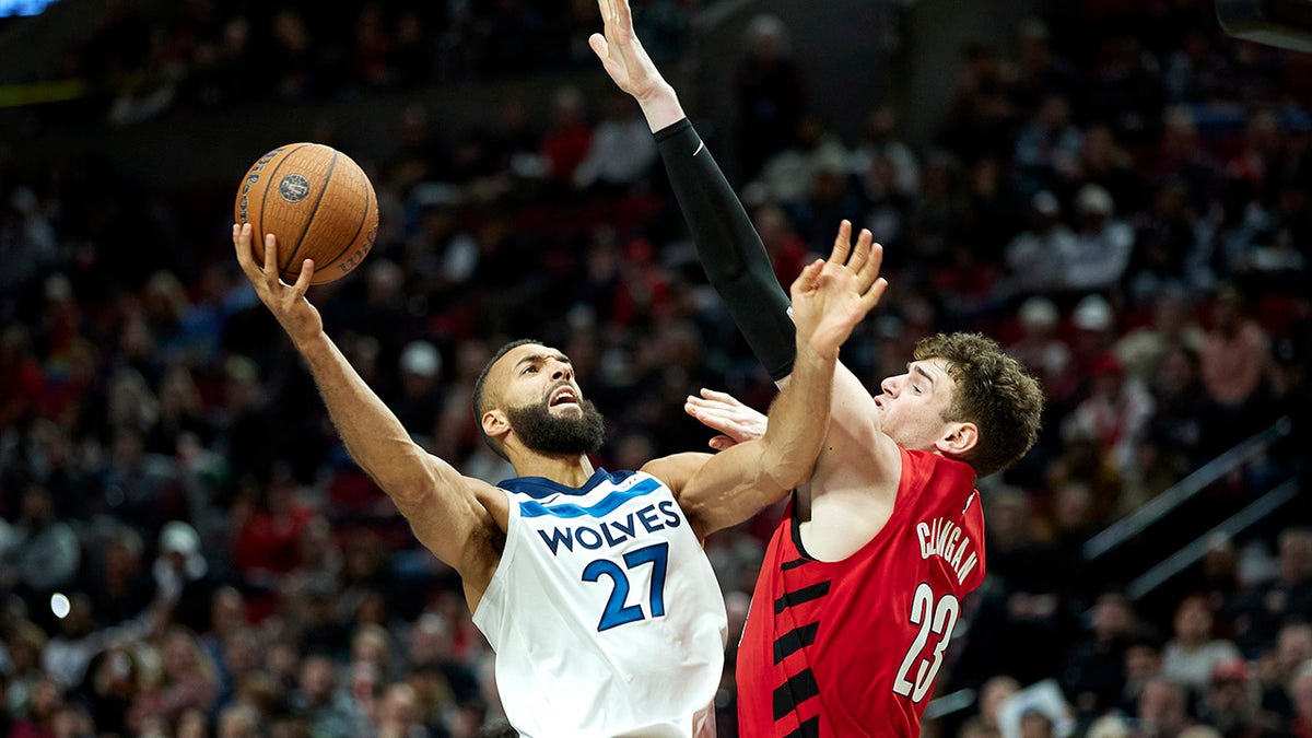 Minnesota Timberwolves center Rudy Gobert, #27, shoots over Portland Trail Blazers center Donovan Clingan, #23, during the second half of an Emirates NBA Cup basketball game in Portland, Oregon, on Tuesday, Nov. 12, 2024.