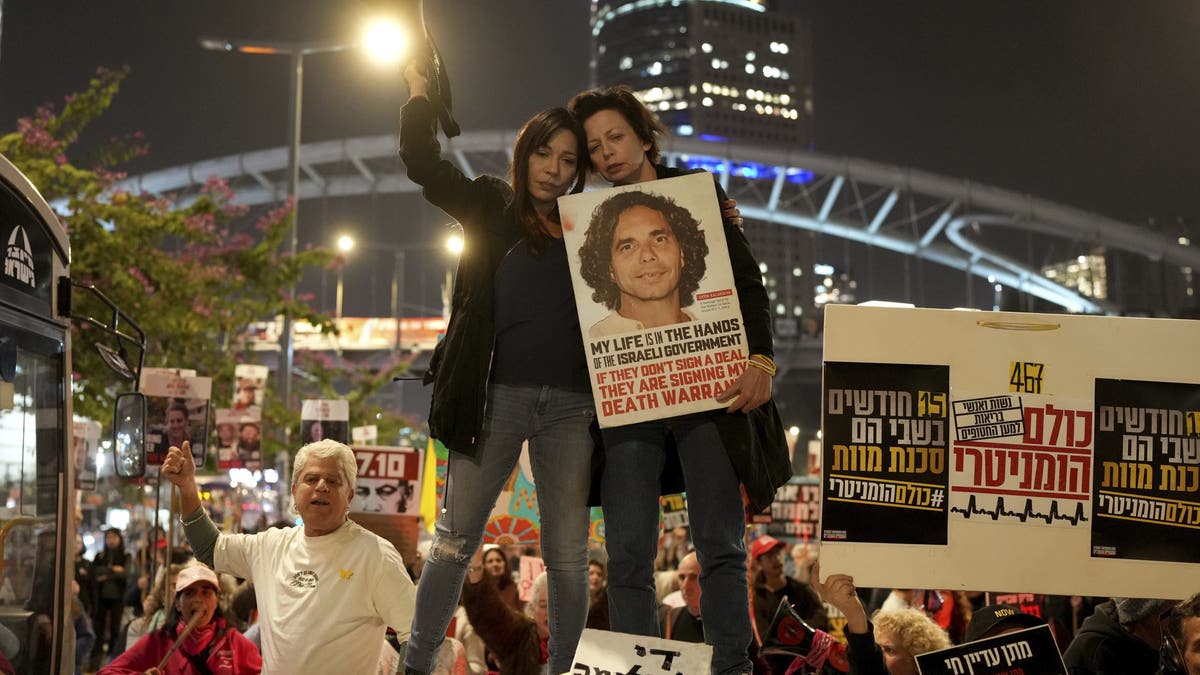 Relatives and friends of people killed or abducted by Hamas and taken into Gaza react to the cease-fire announcement as they take part in a demonstration in Tel Aviv, Israel, Wednesday, Jan. 15, 2025.