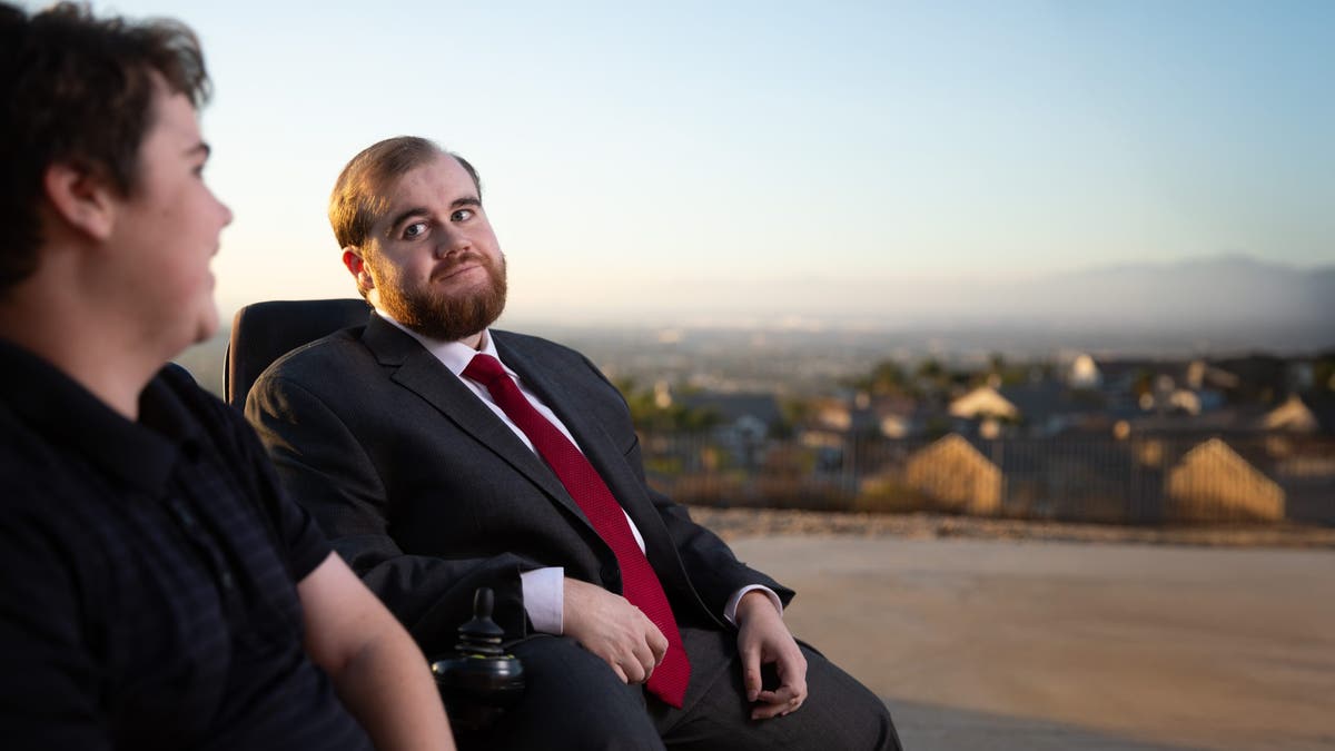 Elijah Stacy (right) looks over at his brother Kai. They are both battling against Duchenne Muscular Dystrophy.    